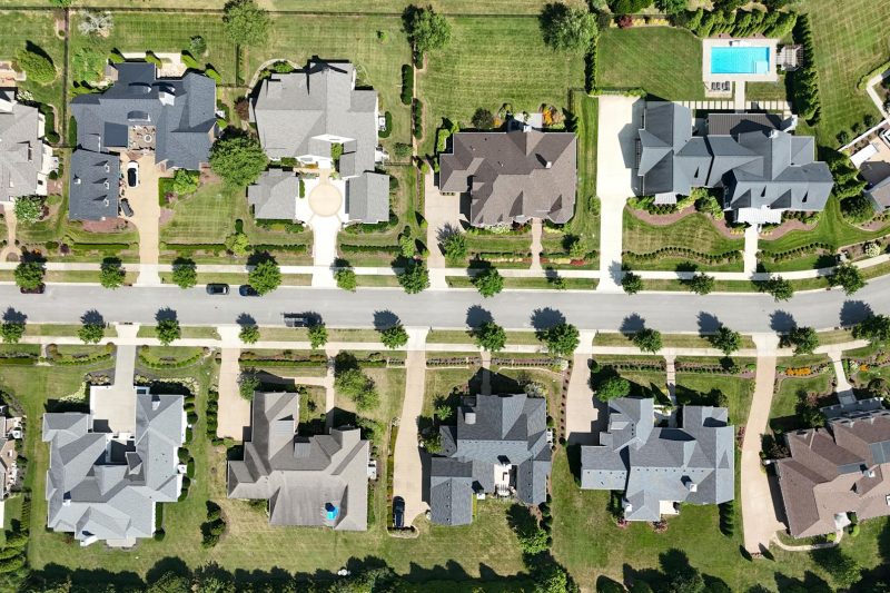 Overhead view of modern homes in a suburban Tennessee neighborhood surrounded by lush greenery.